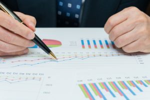 Man looking at charts on a piece of paper