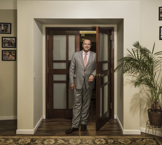 man in suit standing in front of door