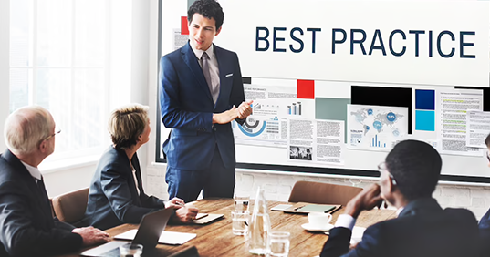 Man presenting in front of a group of coworkers